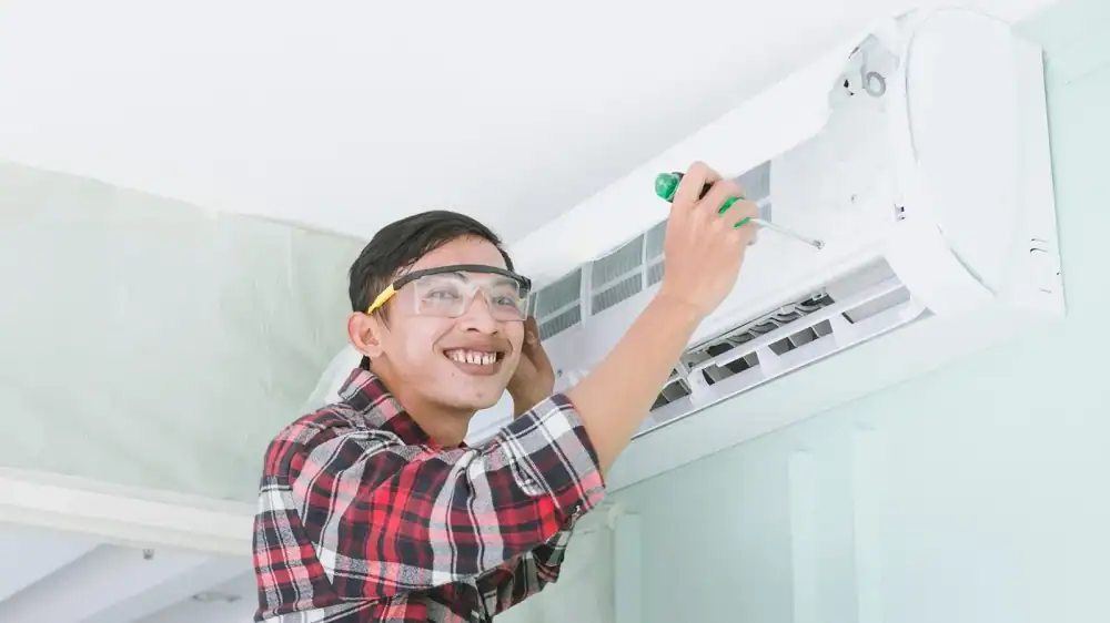 HVAC technician servicing a home air conditioning unit